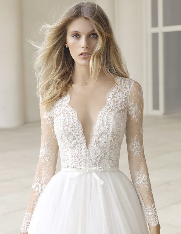 Rosa Clara Couture Pergola Wedding Dress - A line pleated tulle dress featuring a beaded embroidered lace bodice, long sleeves, and a deep V-neckline.