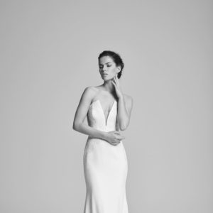 Suzanne Neville Delphine Wedding Dress - Sheath timeless classic strapless Crepe dress with a showstopping deep v-neckline and lace appliqué.