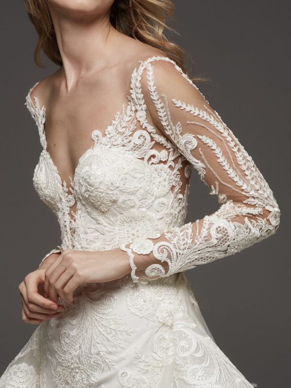 Pronovias Hevea Wedding Dress Sample Sale - Mermaid dress with fitted bodice and overskirt in tulle, long sleeves, deep v neckline with sweetheart cut.