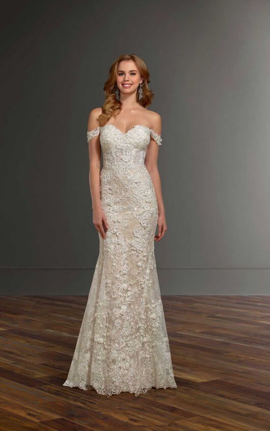 Slight fit and flare dress, off-the-shoulder and embellished pearl-beaded lace with 3-dimensional flowers. Sweetheart neckline extends to drapey, lace, removable off-the-shoulder straps.