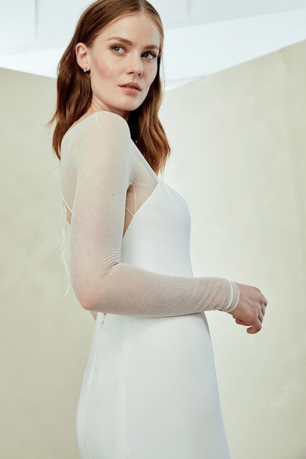 Amsale Aberra Miri Wedding Dress - Crepe slim fit to flare gown with seam detailing, sheer illusion long sleeve. Straight strapless neckline and open back.