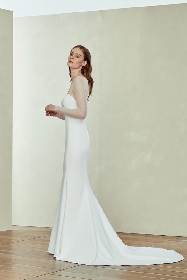 Amsale Aberra Miri Wedding Dress - Crepe slim fit to flare gown with seam detailing, sheer illusion long sleeve. Straight strapless neckline and open back.