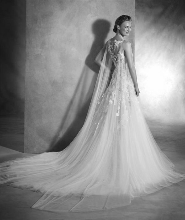 Pronovias Nelsia Wedding Dress - Elegant A-line dress with appliqué flowers and stunning detachable tulle cape, illusion bodice, v-neckline and train.