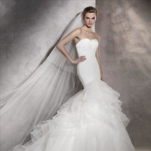 Pronovias Asha Wedding Dress Sample Sale - Fitted, pleated bodice that opens out into a mermaid skirt that explodes into a mass of tulle and nylon ruffles.