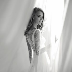 Pronovias Atelier Ribel Wedding Dress Sample Sale - Modified A Line style dress with illusion tattoo style long sleeves, crepe and lace bateau neckline and low open back.