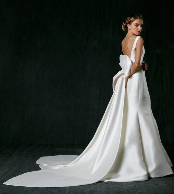 Sareh Nouri Naomi Wedding Dress - Soft trumpet gown made of Mikado with boat necklace, U-shaped back, cathedral bow detail and train.