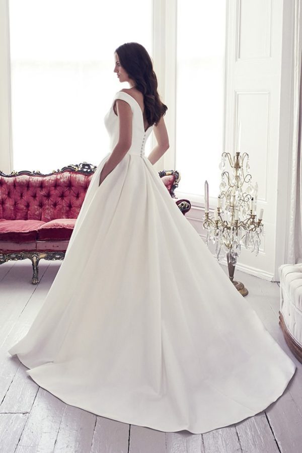 Suzanne Neville Monet Wedding Dress - Stunning off the shoulder ball gown with bateau neckline and belt detail in zibeline with princess seams.