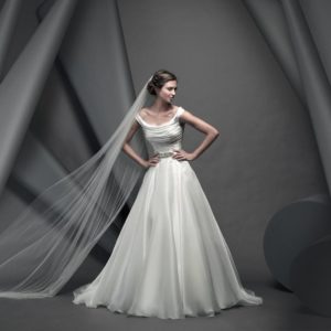 Suzanne Neville Savoy Wedding Dress Sample Sale - Ballgown with ruched fitted bodice, off the shoulder bateau neckline, full organza skirt and beaded belt.