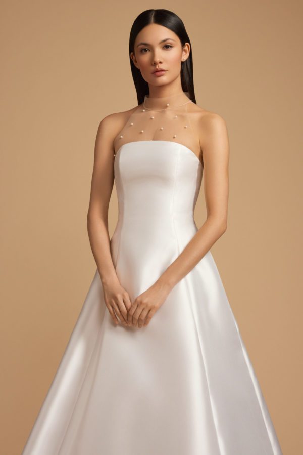 Allison Webb Baxley Wedding Dress - Snow mikado A-line gown with crescent neckline, and origami half bow, and chapel train. Optional pearl illusion halter.
