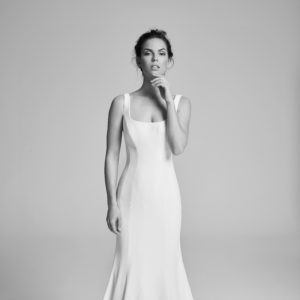 Suzanne Neville Coco Wedding Dress - Simple, sexy matte crepe fit and flare dress with scoop neck, straps and button back detailing.
