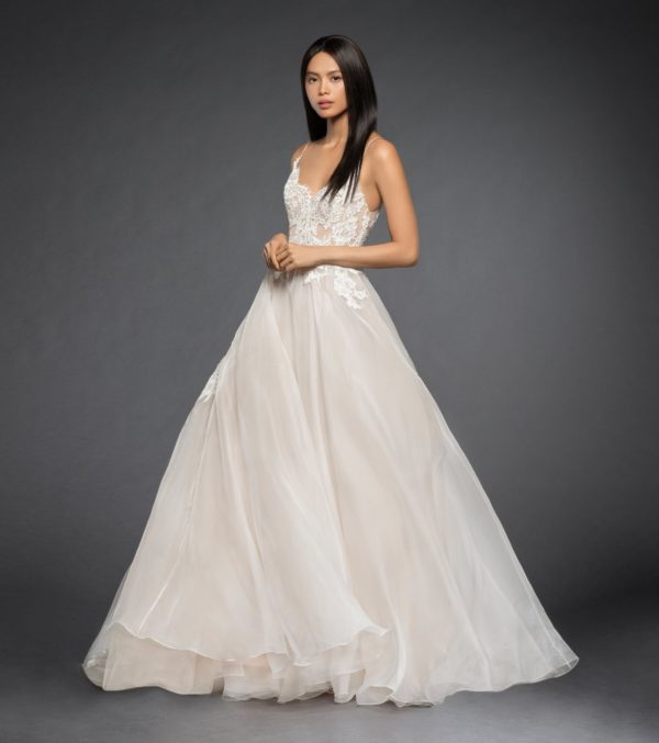 Lazaro Vanessa 3860 Wedding Dress - Silk organza A-line bridal gown, scalloped ballerina neckline with crisscross straps at open back, shear lace bodice over nude lining, circular A line organza skirt accented with lace appliqués.