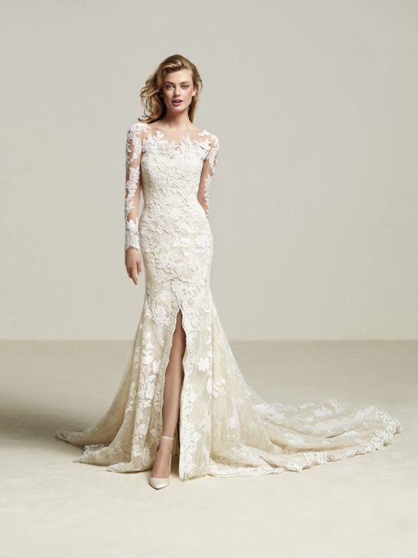 Pronovias Driate Wedding Dress Sample Sale - Mermaid dress with Illusion neck, long sleeves, semi sweetheart neckline, and front split in skirt with train.