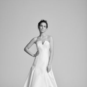 Suzanne Neville Ralston Wedding Dress - Strapless, A-line style dress in Italian Pique fabric with plunging v-neckline and pleated skirt.