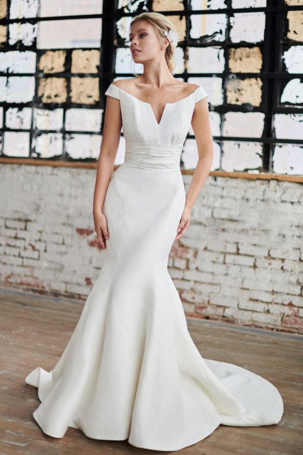 Tulle NY Beck Wedding Dress – Silk shantung, fit & flare, off the shoulder gown with a ruched cummerbund waistline and notched neckline.