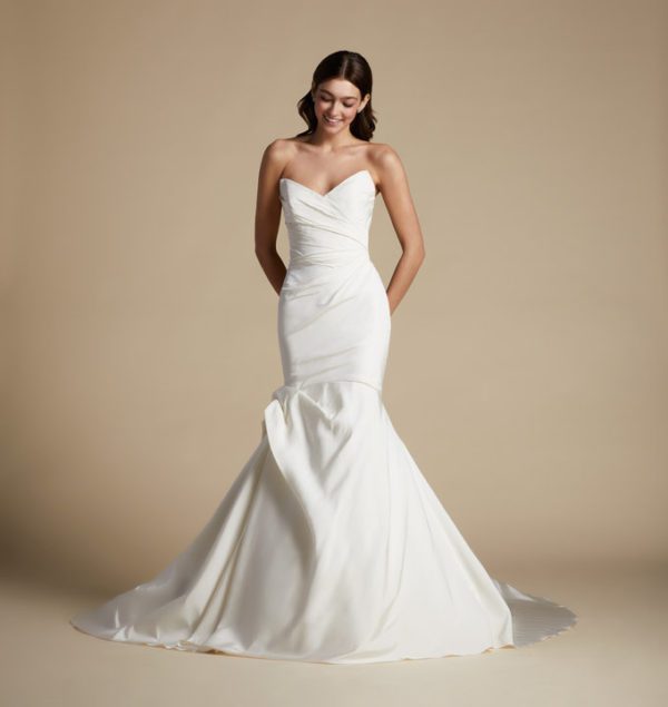Allison Webb Carson Wedding Dress - Fit and flare Pearl blended gown, including a peaked neckline, draping & pleating elements with an origami half bow.