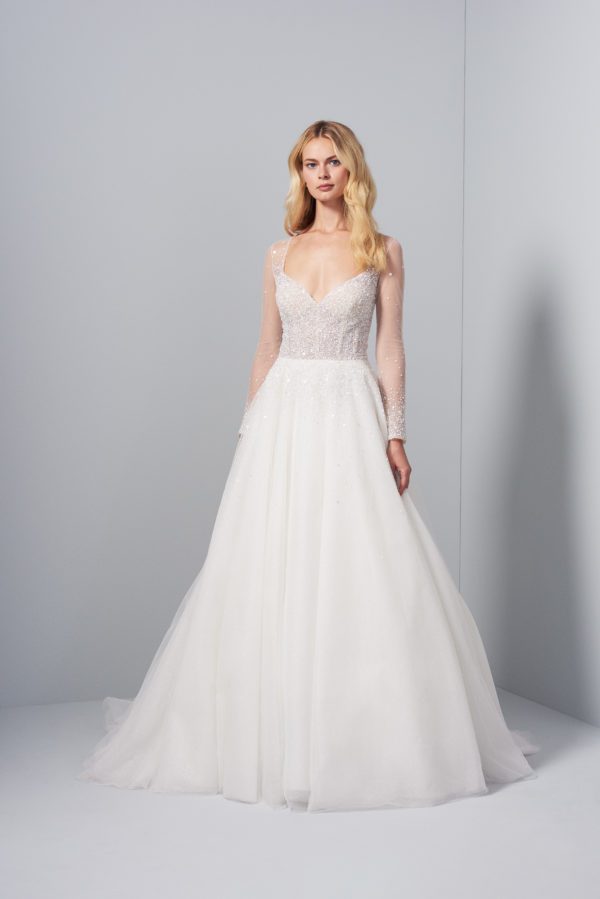 Allison Webb Kinley Wedding Dress - An Ivory net and twinkle tulle A-line gown with sequins sprinkled throughout bodice and illusion sleeves.