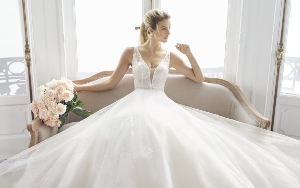 Rosa Clara Aire Estelar Wedding Dress - Elegant deep V neckline beaded ball gown with thin straps, open back and long train.