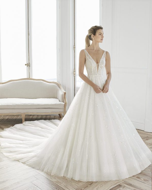 Rosa Clara Aire Estelar Wedding Dress - Elegant deep V neckline beaded ball gown with thin straps, open back and long train.