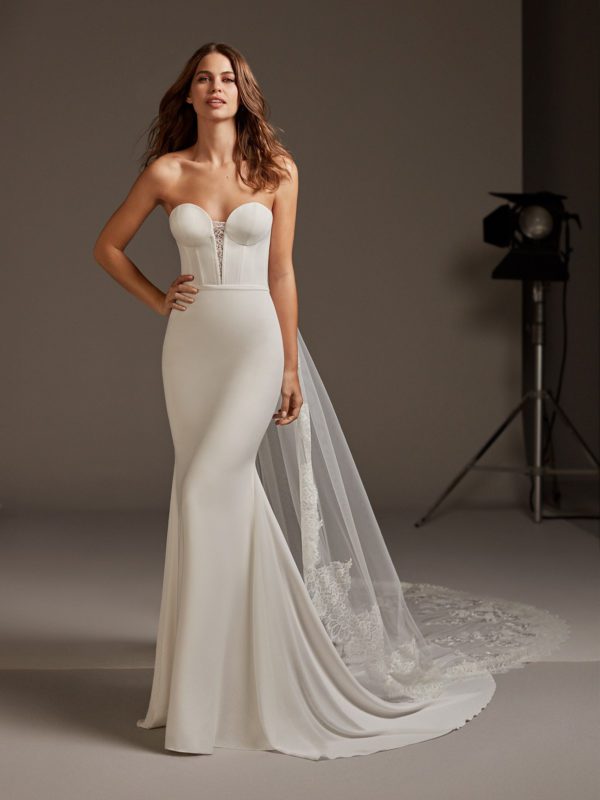 Pronovias Antares Wedding Dress - Mermaid dress with a statement corsetry and luxe crepe with deep sweetheart neckline, covered buttons and train.