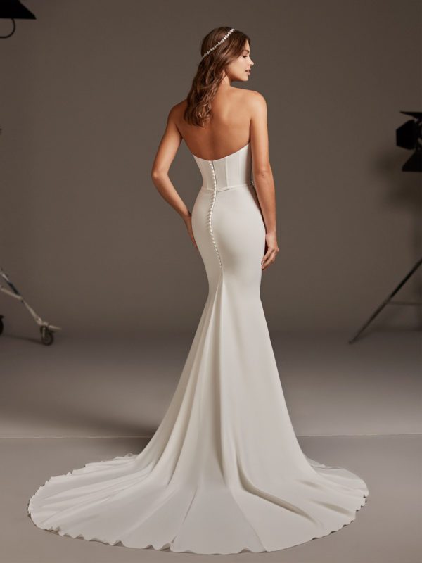 Pronovias Antares Wedding Dress - Mermaid dress with a statement corsetry and luxe crepe with deep sweetheart neckline, covered buttons and train.
