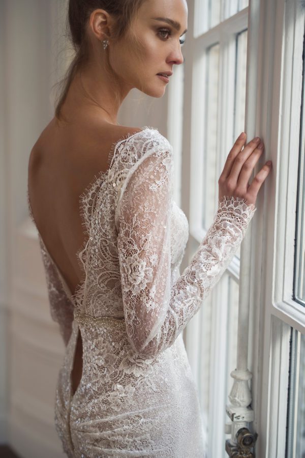 Netta BenShabu Polly Wedding Dress - Fit and flare style dress with long sleeves, deep plunging neckline, and a open low back with elegant triangle train.