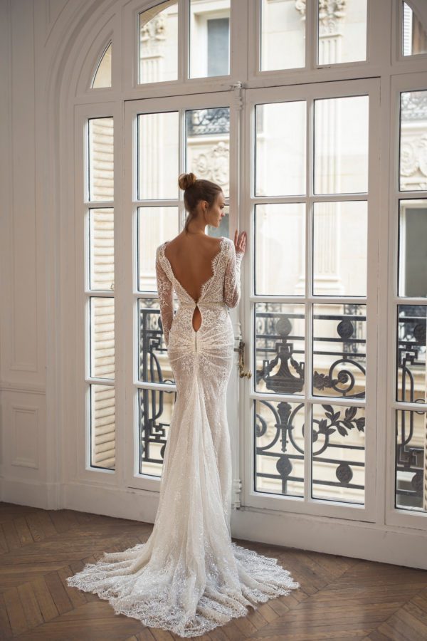 Netta BenShabu Polly Wedding Dress - Fit and flare style dress with long sleeves, deep plunging neckline, and a open low back with elegant triangle train.