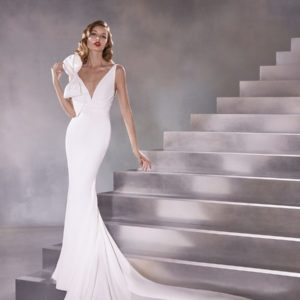 Pronovias Orbit Wedding Dress Sample Sale - Mermaid style in crepe with a bow along the right strap of the bodice, V-neckline and open back with train.