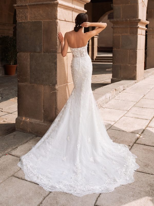 Pronovias Aethra Wedding Dress - Mermaid gown with 3D flowers along the deep v-neckline that gather at the waist and cascade down the skirt.