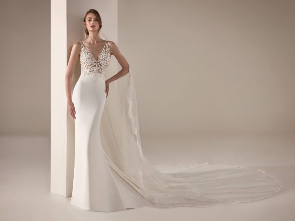 Pronovias Yari Wedding Dress Sample Sale - Mermaid style with illusion bodice, deep v-neckline, embroidered roses on bodice, and crepe skirt.