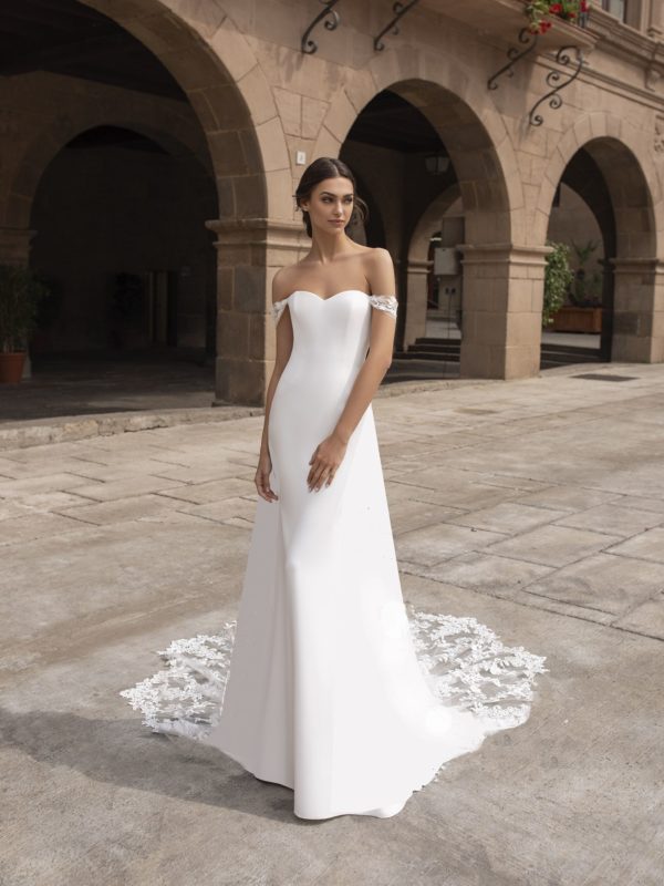 Pronovias Syrinx Wedding Dress Sample Sale - Sheath style with strapless sweetheart neckline, clean crepe fabric, off-the-shoulder straps, open back and train.
