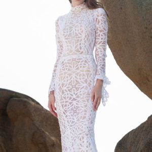 LaPremiere x Inbal Dror Ysera Wedding Dress - Cut out lace sheath dress featuring long bell sleeves, a high neckline, and an open back.