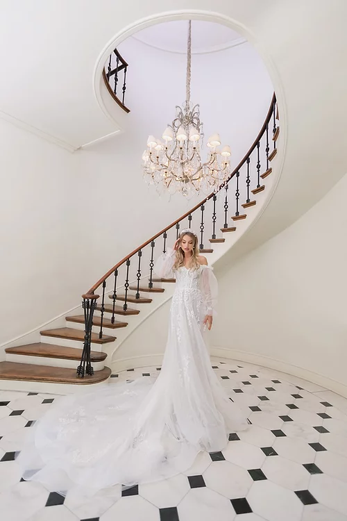 Estee Couture Kiki Wedding Dress - A Line style with a modified sweetheart neckline, Off the shoulder straps, detachable long sleeves and Train.