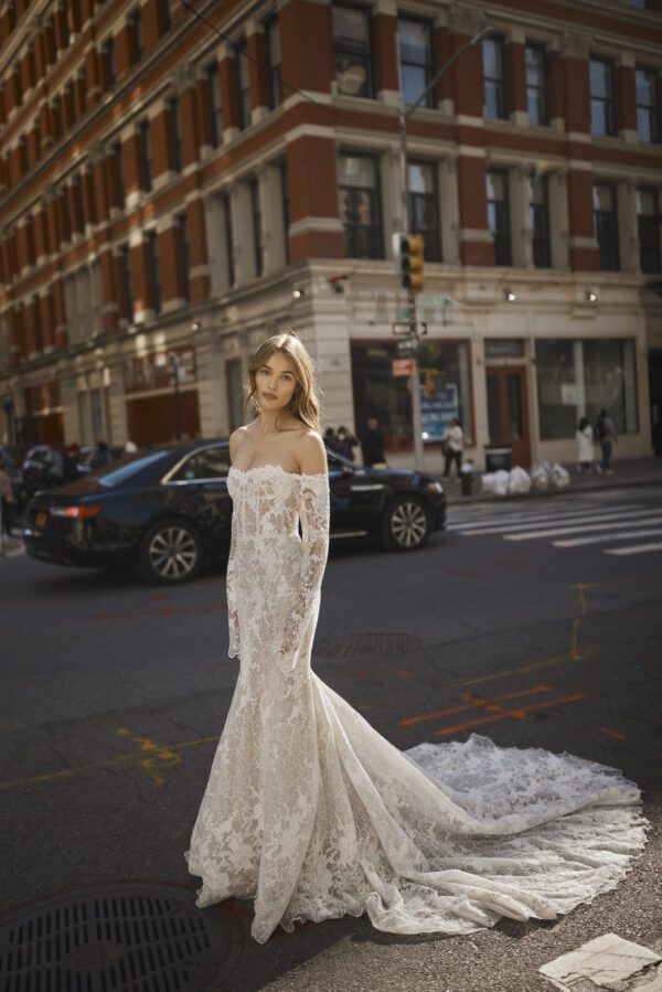 Netta BenShabu Diana Wedding Dress – Beaded lace, fit and flare gown with an illusion bodice, off the shoulder long flare sleeves and sheer low back.