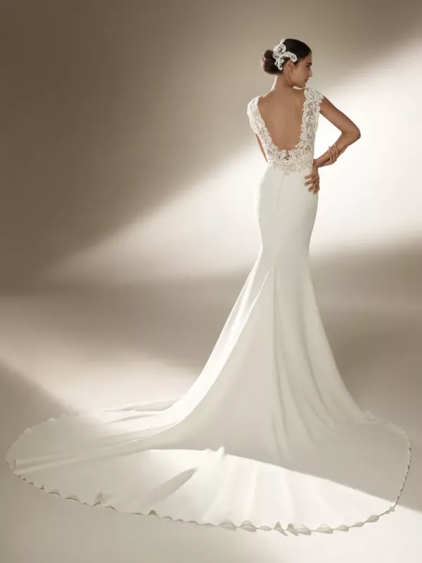 Pronovias Atelier Swanson Wedding Dress — Sheath crepe dress with low cut v-neckline, Open back, embroidery, cap sleeves and full chapel train.