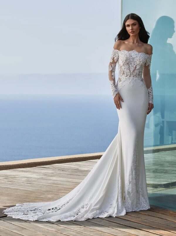 Pronovias Della Wedding Dress - Off the shoulder mermaid dress in crepe fabric with tattoo-effect long sleeves, fitted bodice & delicate scallop-edge train. 