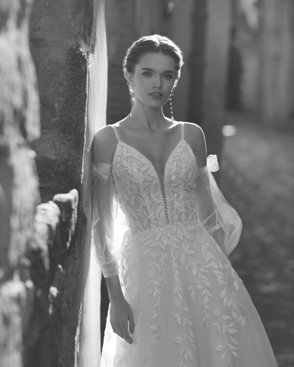 Rosa Clara Boho Usqo Wedding Dress - A-Line sheath-style cut with plunging neckline, delicate straps, botanical lace, sleeves, open back, tulle skirt. 