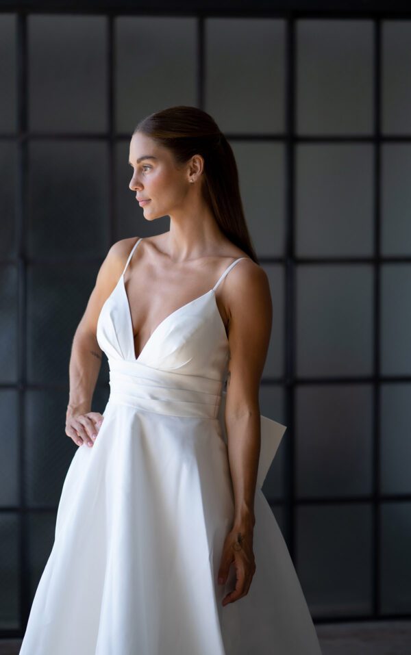 Martina Liana 1560 Wedding Dress - A Line with spaghetti straps, v-neckline, low squared back, detachable bow, covered buttons down the back and long train. 