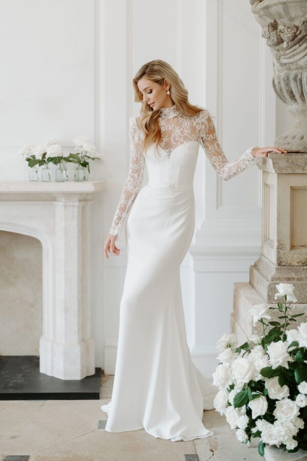 Suzanne Neville Manoir Wedding Dress - Fit and flare dress with illusion French lace high neckline, fitted bodice, sweetheart neckline and long sleeves