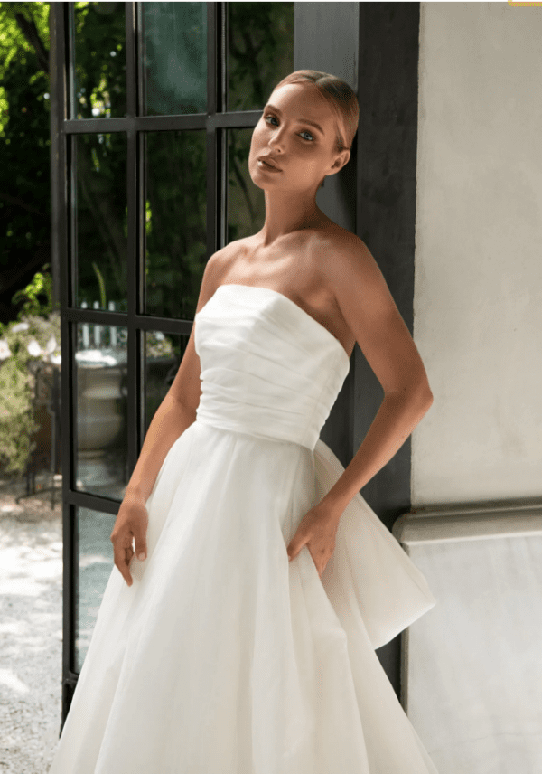 Tulle NY Belle Wedding Dress - Silk organza strapless ball gown with a horizontally draped bodice and full ball gown skirt with bow detail at center back.