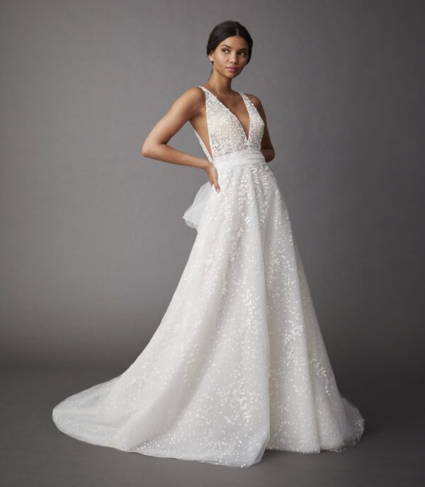 Allison Webb Lillia Wedding Dress - Sheer plunging V-neck A-line gown with delicate floral embellishments over sparkle dotted tulle and a tulle sash.