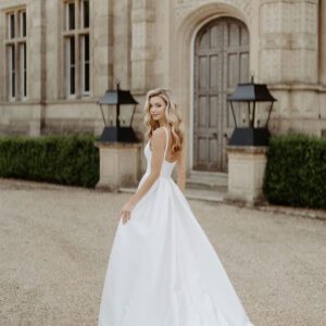 Suzanne Neville Bloomsbury Wedding Dress - A Line with square neckline contouring into a striking plunge with a structured skirt in mikado fabric. 