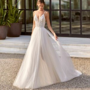 Rosa Clara Oman Wedding Dress - Modern A-line silhouette, sparkly bodice, V-neckline, see-through straps with its delicate tulle skirt from the waist.
