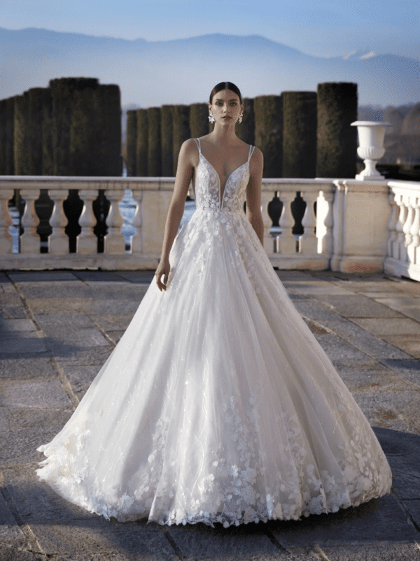 Pronovias Delaney Wedding Dress - Hand-worked lace appliqué, flowers effect, deep neckline, side cutaways and plunge back finished with beaded straps.