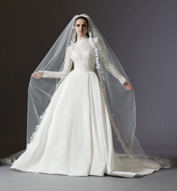 Lazaro 32250 Austen Wedding Dress - Trumpet style with detachable overskirt, high neckline, long fitted sleeve, skirt with side pockets, and chapel train.