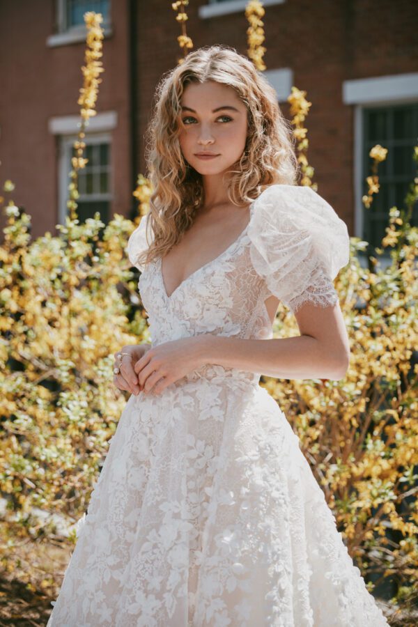 Lazaro Genevieve 32257 Wedding Dress - Ballgown with V-neckline, keyhole back, short sleeves, natural waist, skirt with horsehair trim, and chapel train.