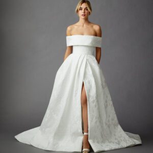 Allison Webb Aubrey Wedding Dress - Italian Snow Floral Jacquard A-line gown with pearl trim at neckline, slit skirt, and buttons to the end of the train