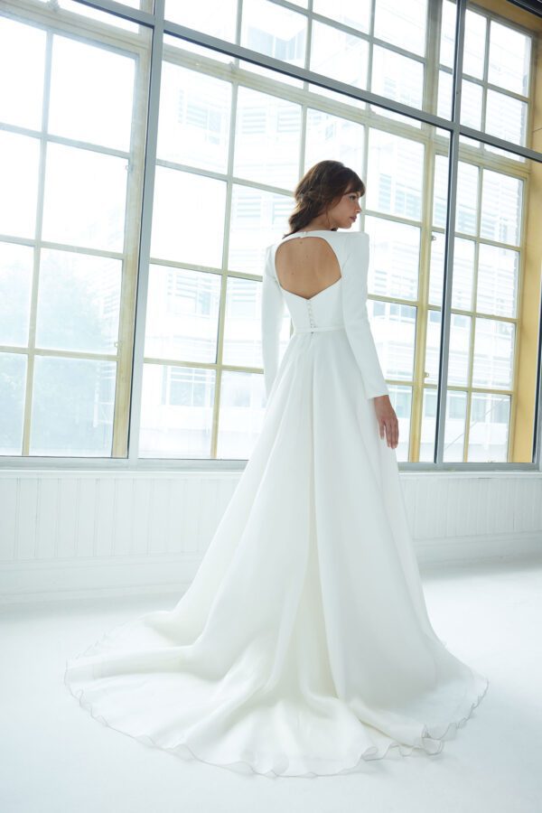 Suzanne Neville Conrad Wedding Dress - A Line, striking neckline, V plunge, framed with long sleeves. Back