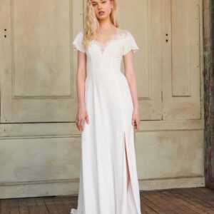Christos Maven T402 Wedding Dress Sample Sale - A daring slit and deep V neckline on a Chantilly lace and crepe gown with fluttering sleeves.