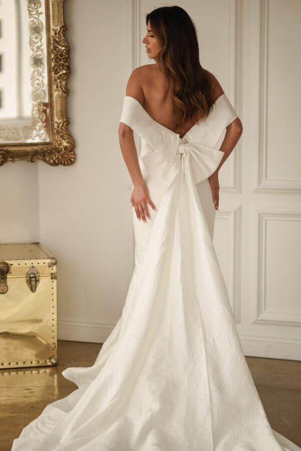 Martina Liana 1619 Wedding Dress - Fit and flare style dress with strapless neckline, detachable off the shoulder wrap, bow detail on back and train.