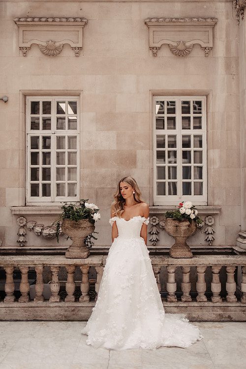 Suzanne Neville Debussy & Overskirt Wedding Dress - A - Line overskirt with a cupped corseted bodices and off the shoulder delicate sleeves in floral tulle.